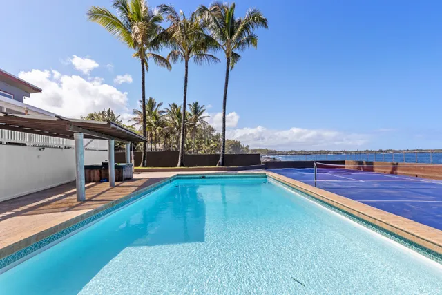 a view of a swimming pool with a table and chairs