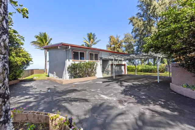 a view of a house with a yard and tree s