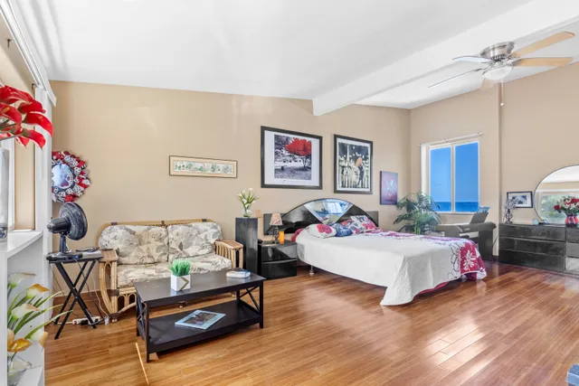 a bedroom with furniture and a wooden floor