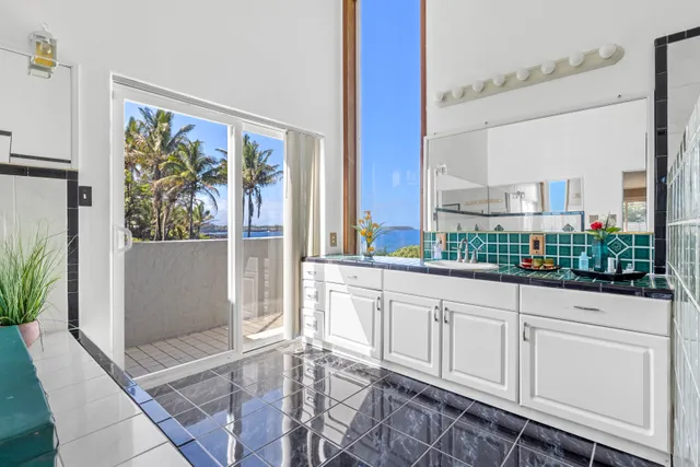 a large white kitchen with a large window