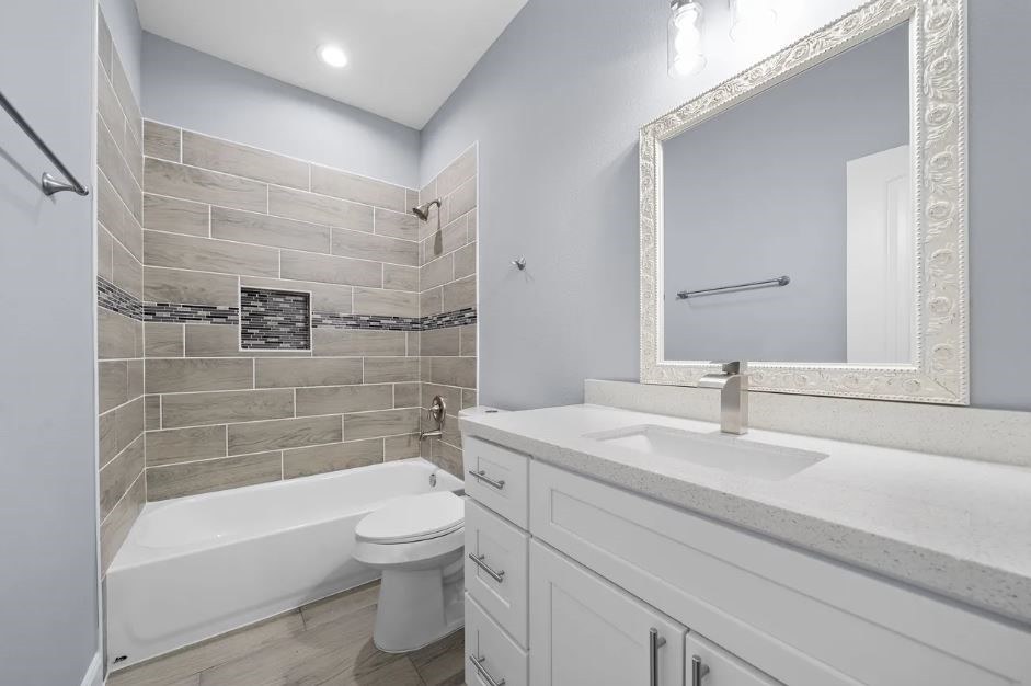 5222 Bataan Road Houston, TX 77033 - Photo 12 of 22 Elegant bathroom with refined tile work, bright lighting, and a polished modern design.