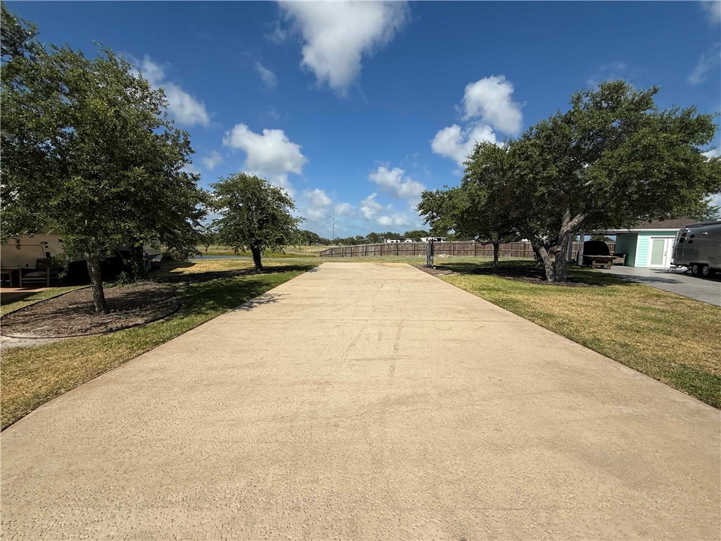 5 Augusta Circle Ingleside, TX 78362 - Photo 1 of 27 a view of swimming pool with outdoor seating and trees in the background