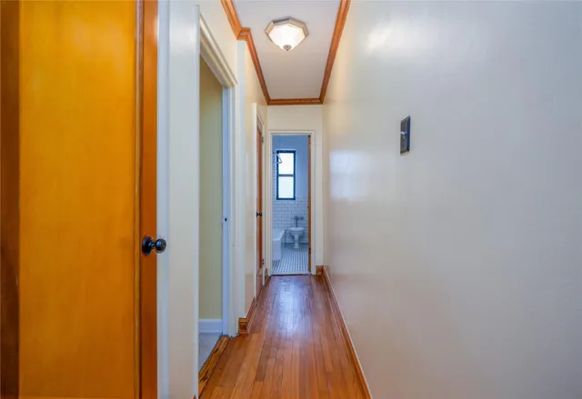 a view of a hallway with wooden floor