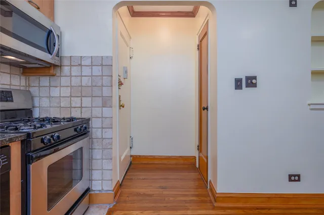 a kitchen with granite countertop a stove and a refrigerator