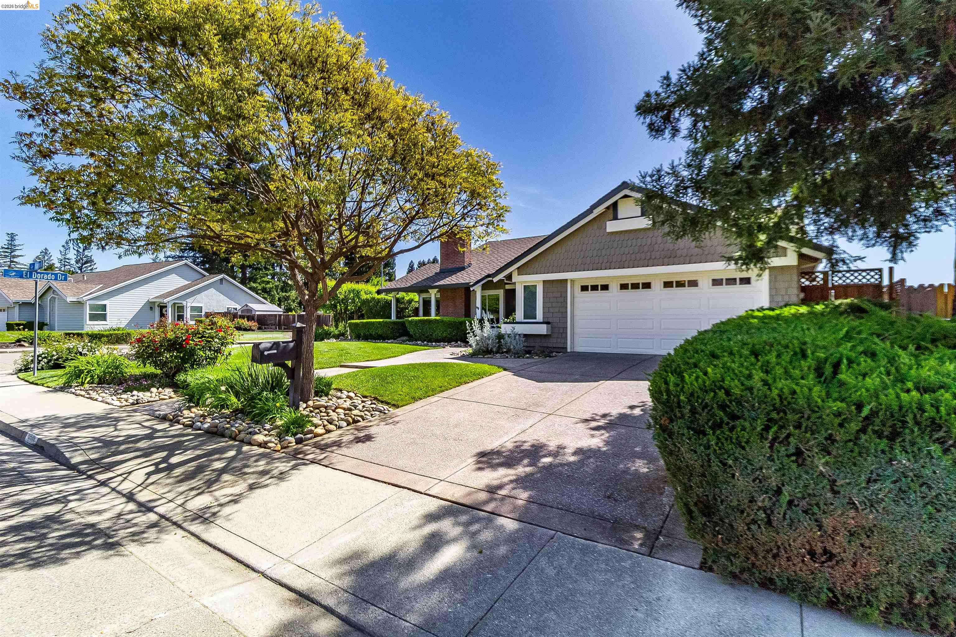 9980 Mangos Drive San Ramon, CA 94583 - Photo 2 of 41 View of front of property with driveway, an attached garage, and a chimney