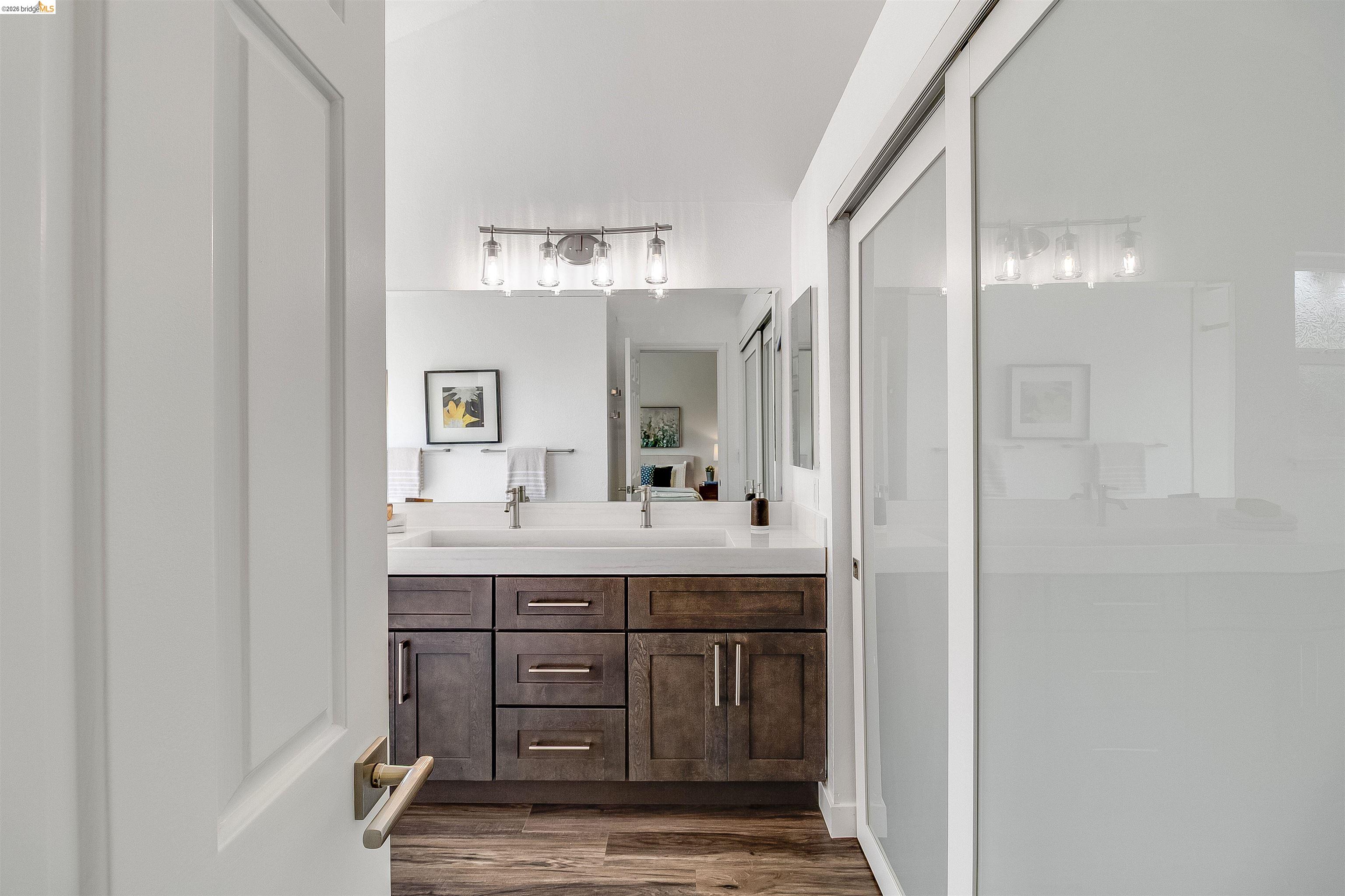 9980 Mangos Drive San Ramon, CA 94583 - Photo 21 of 41 Full bathroom featuring double vanity, dark wood-style flooring, and a shower stall