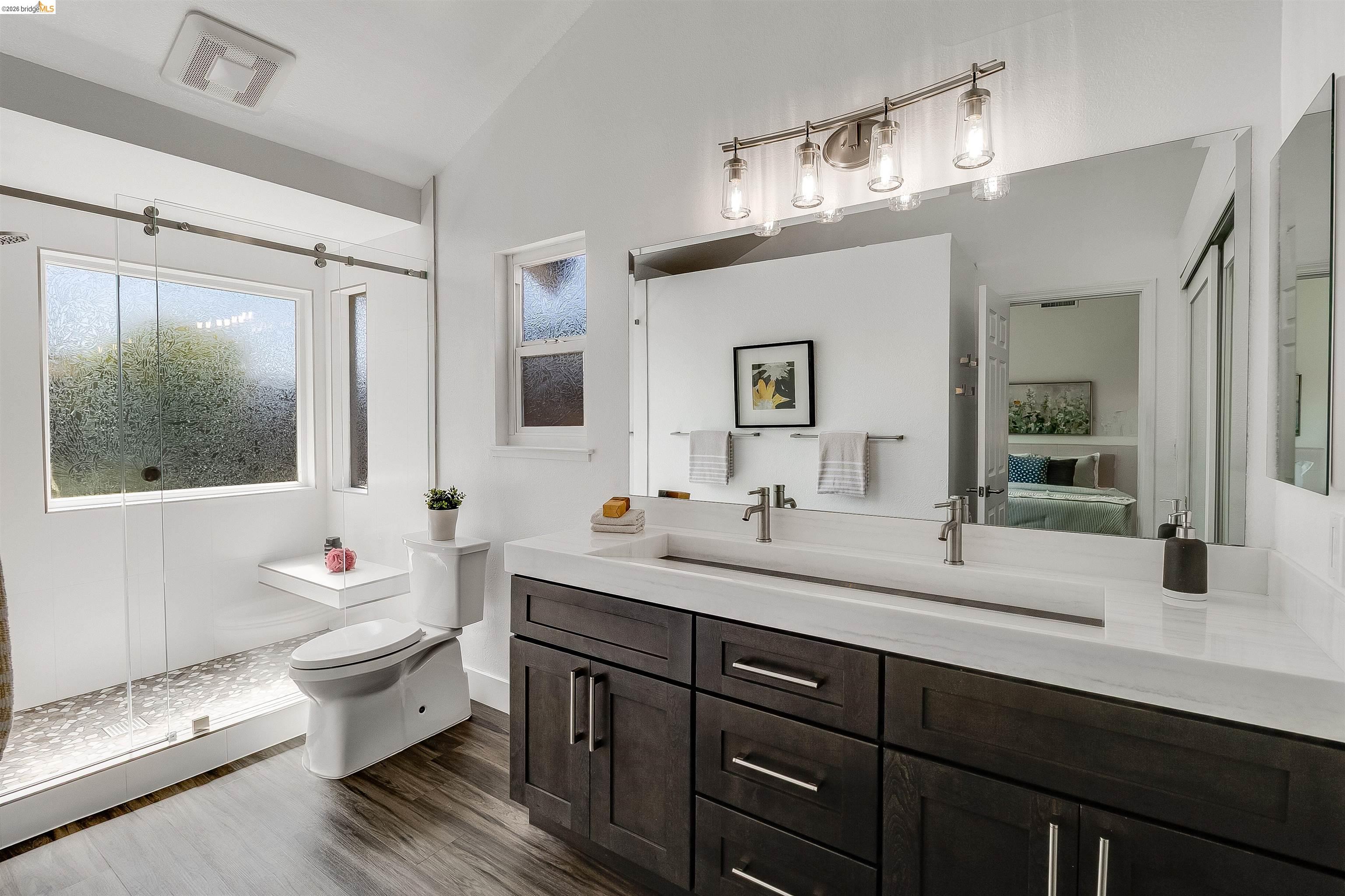 9980 Mangos Drive San Ramon, CA 94583 - Photo 22 of 41 Ensuite bathroom featuring double vanity, vaulted ceiling, a shower stall, and dark wood finished floors