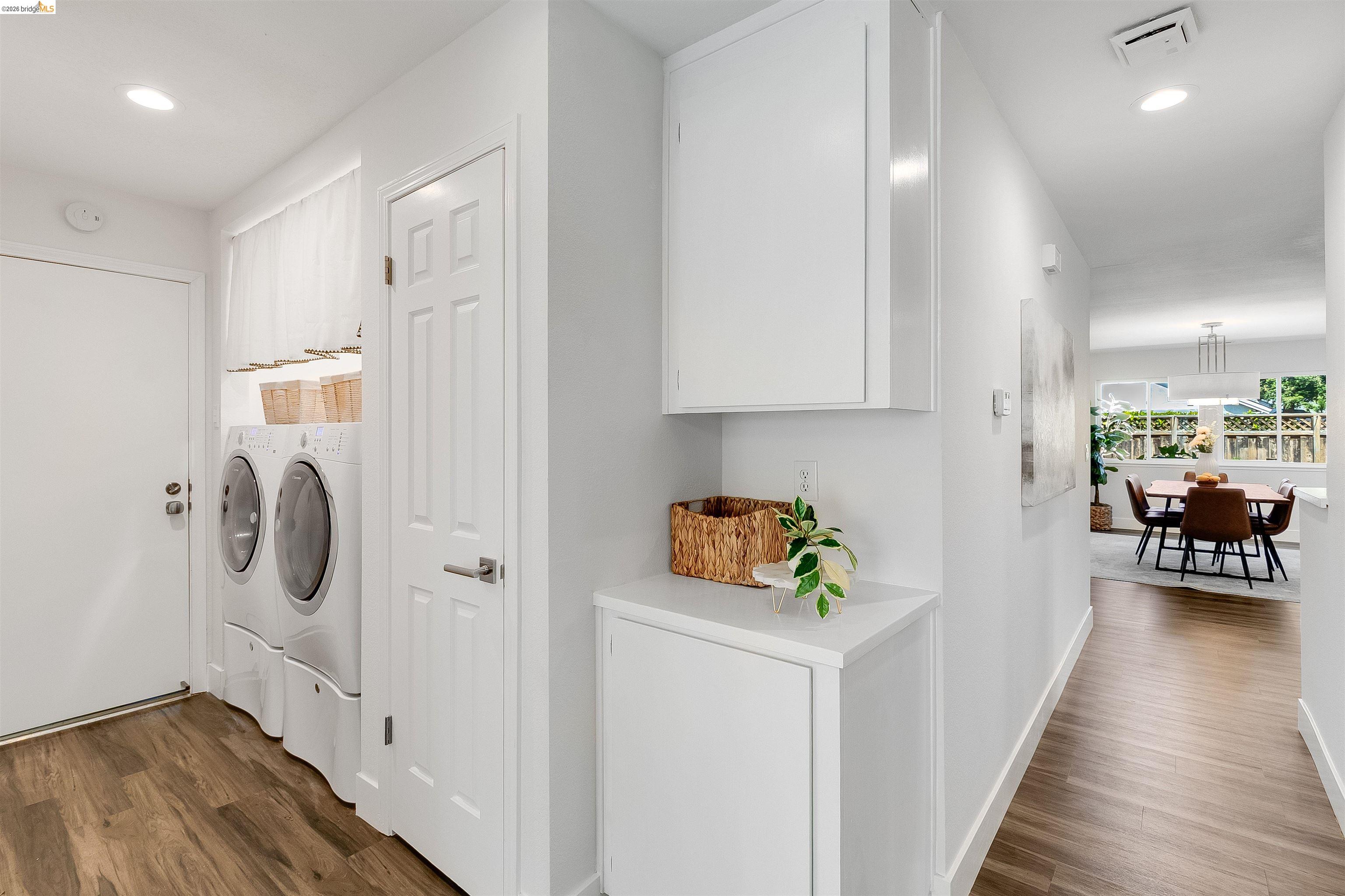 9980 Mangos Drive San Ramon, CA 94583 - Photo 25 of 41 Laundry area featuring recessed lighting, dark wood-style floors, independent washer and dryer, and cabinet space