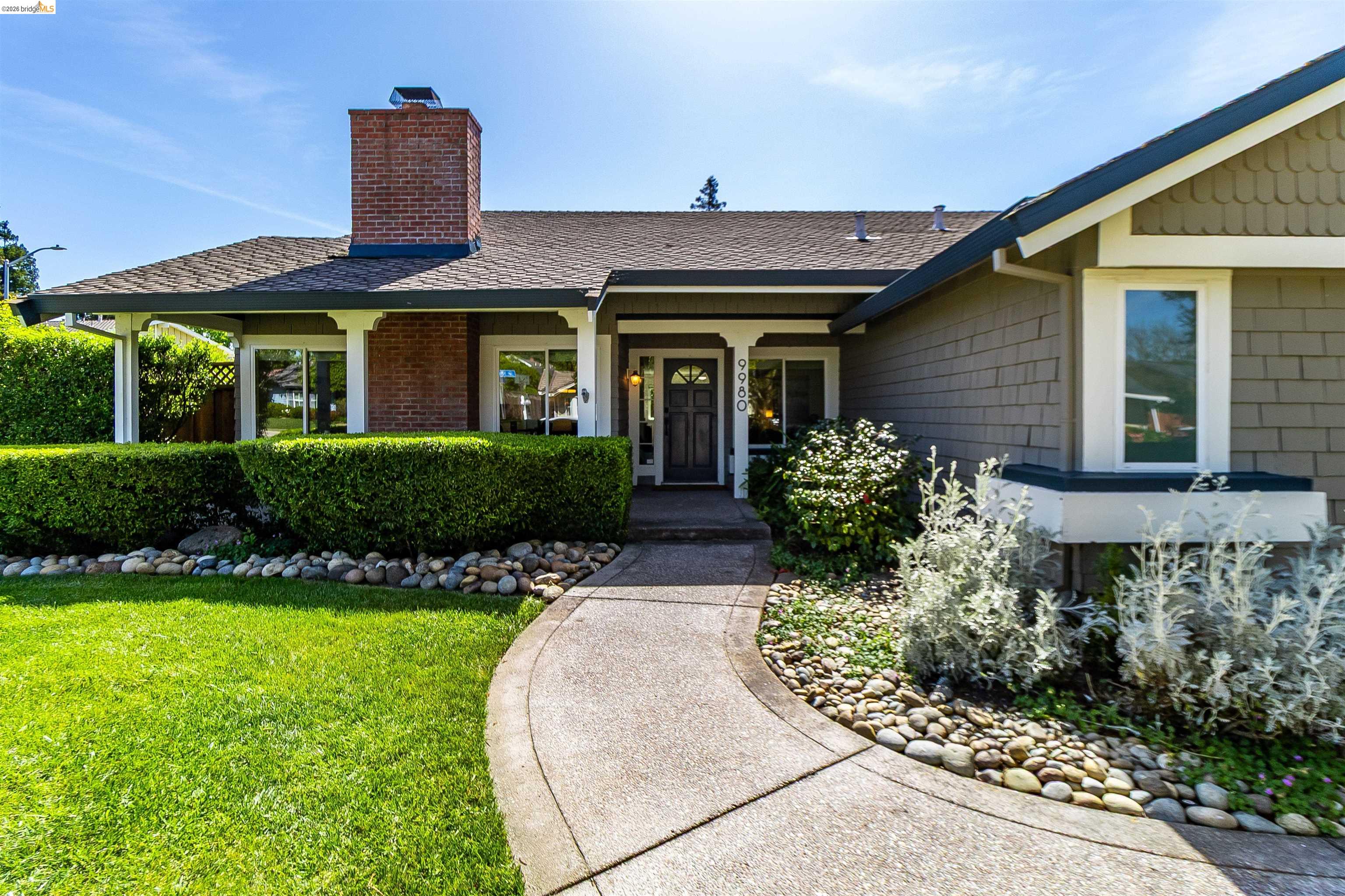 9980 Mangos Drive San Ramon, CA 94583 - Photo 3 of 41 View of front of house featuring a chimney, a porch, roof with shingles, and a front yard