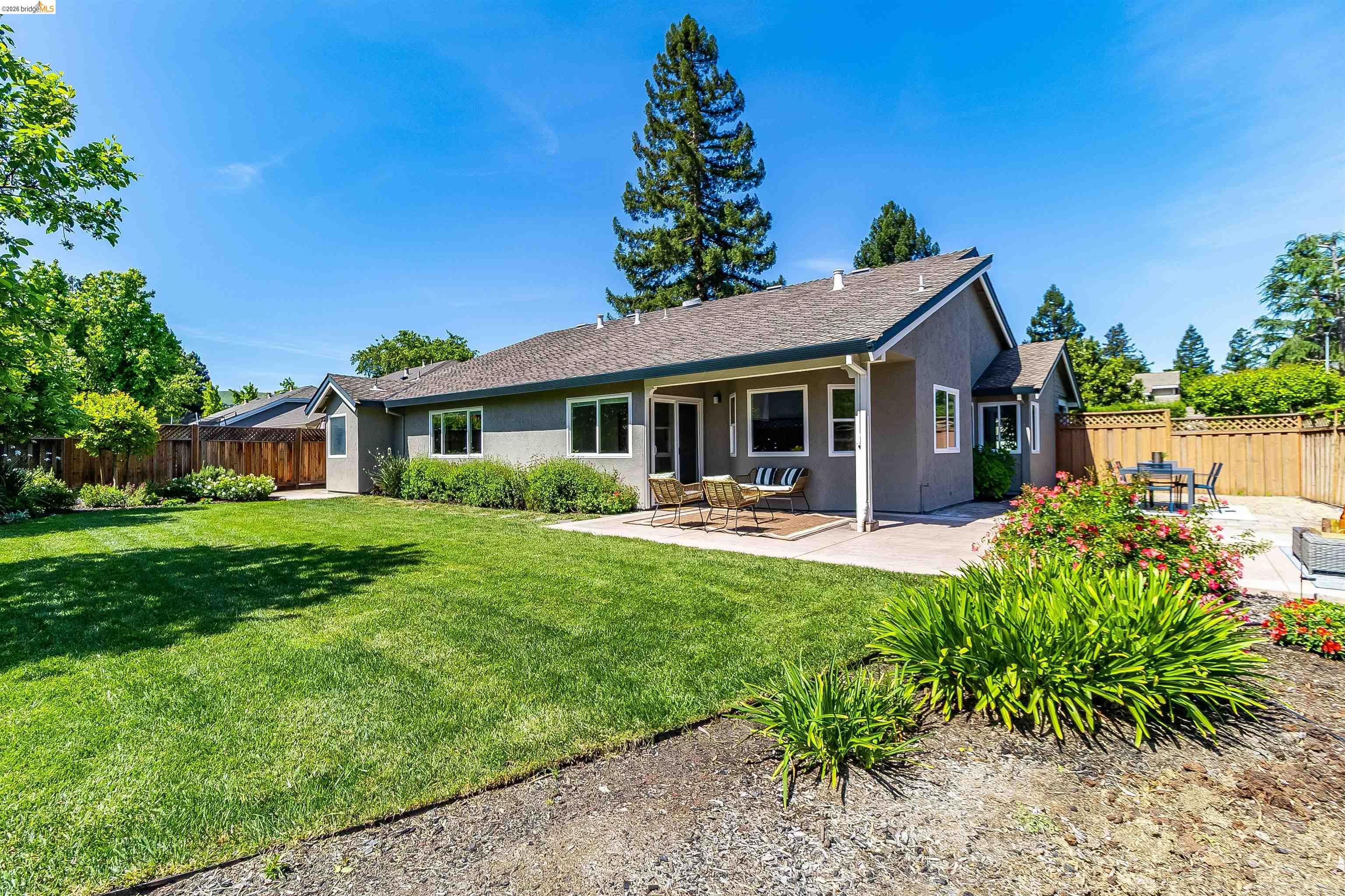 9980 Mangos Drive San Ramon, CA 94583 - Photo 31 of 41 Back of house with a patio, a fenced backyard, stucco siding, and roof with shingles