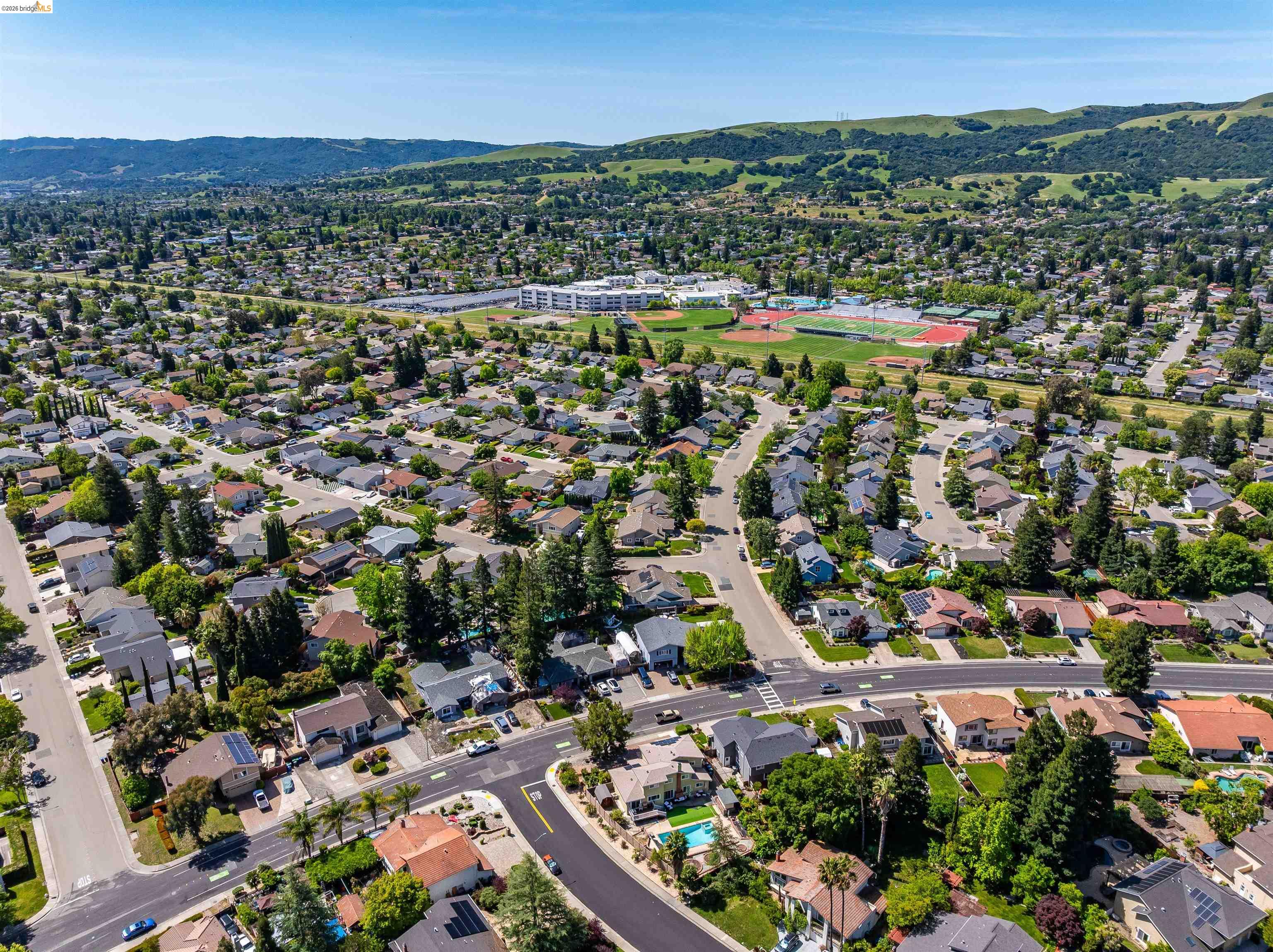9980 Mangos Drive San Ramon, CA 94583 - Photo 39 of 41 Aerial view of property's location with a mountain backdrop and nearby suburban area