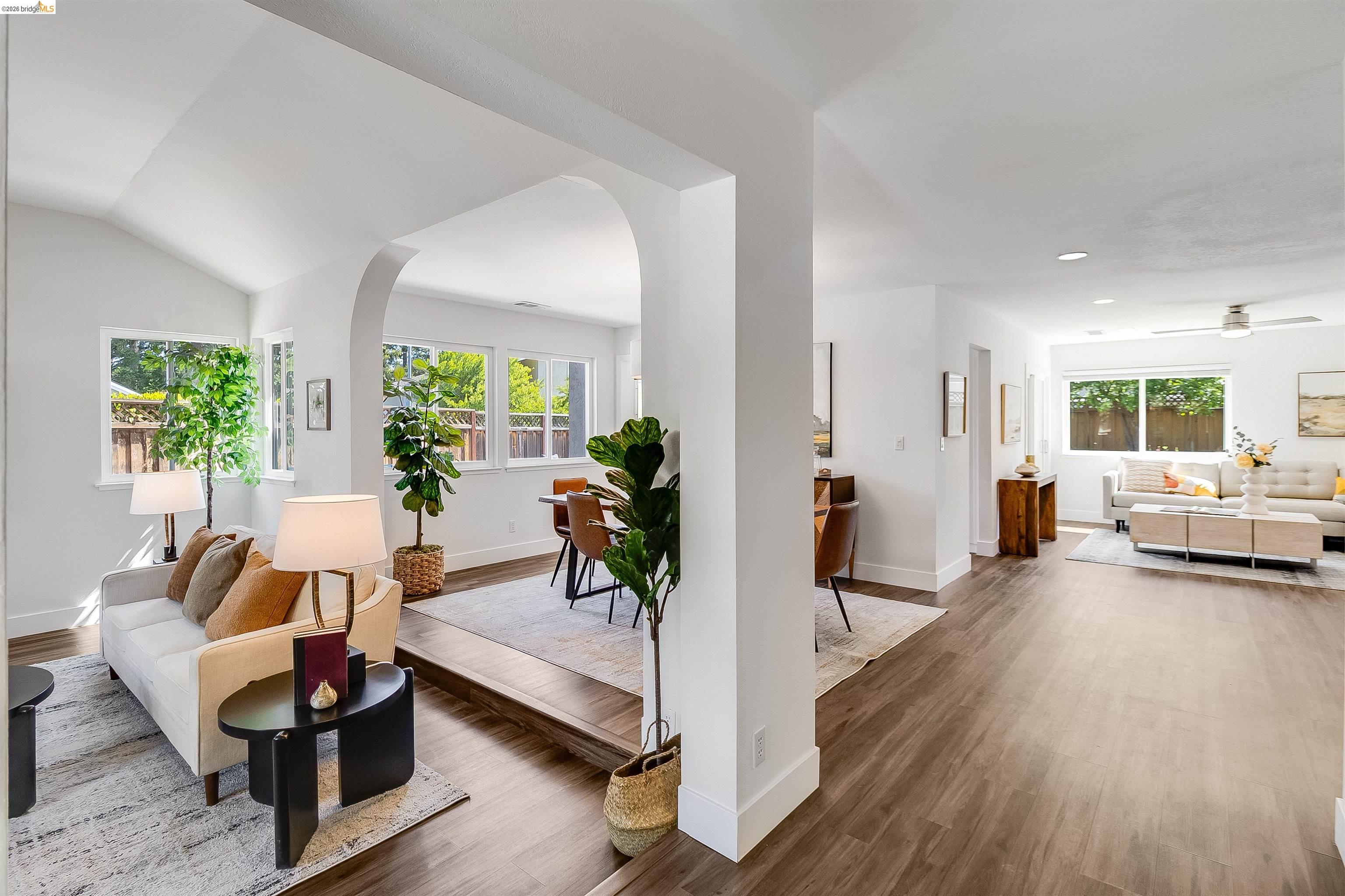 9980 Mangos Drive San Ramon, CA 94583 - Photo 5 of 41 Living area featuring arched walkways, dark wood-style floors, and a ceiling fan