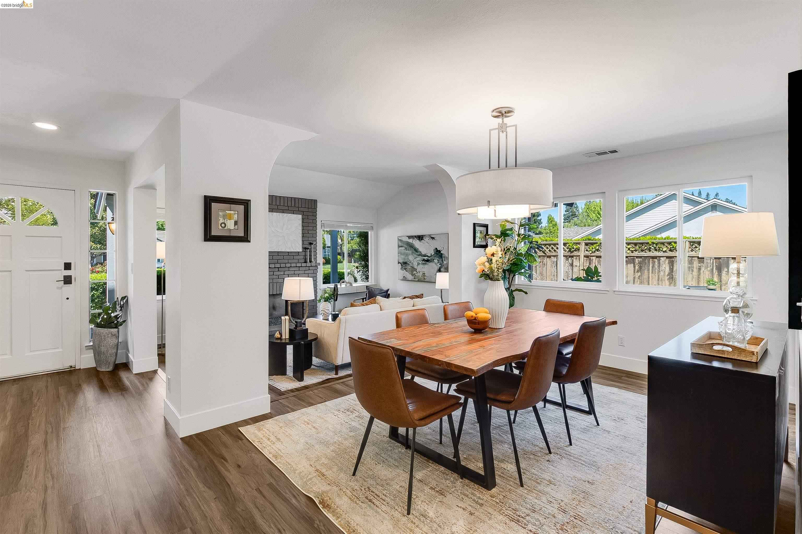 9980 Mangos Drive San Ramon, CA 94583 - Photo 6 of 41 Dining room with wood finished floors, arched walkways, and vaulted ceiling