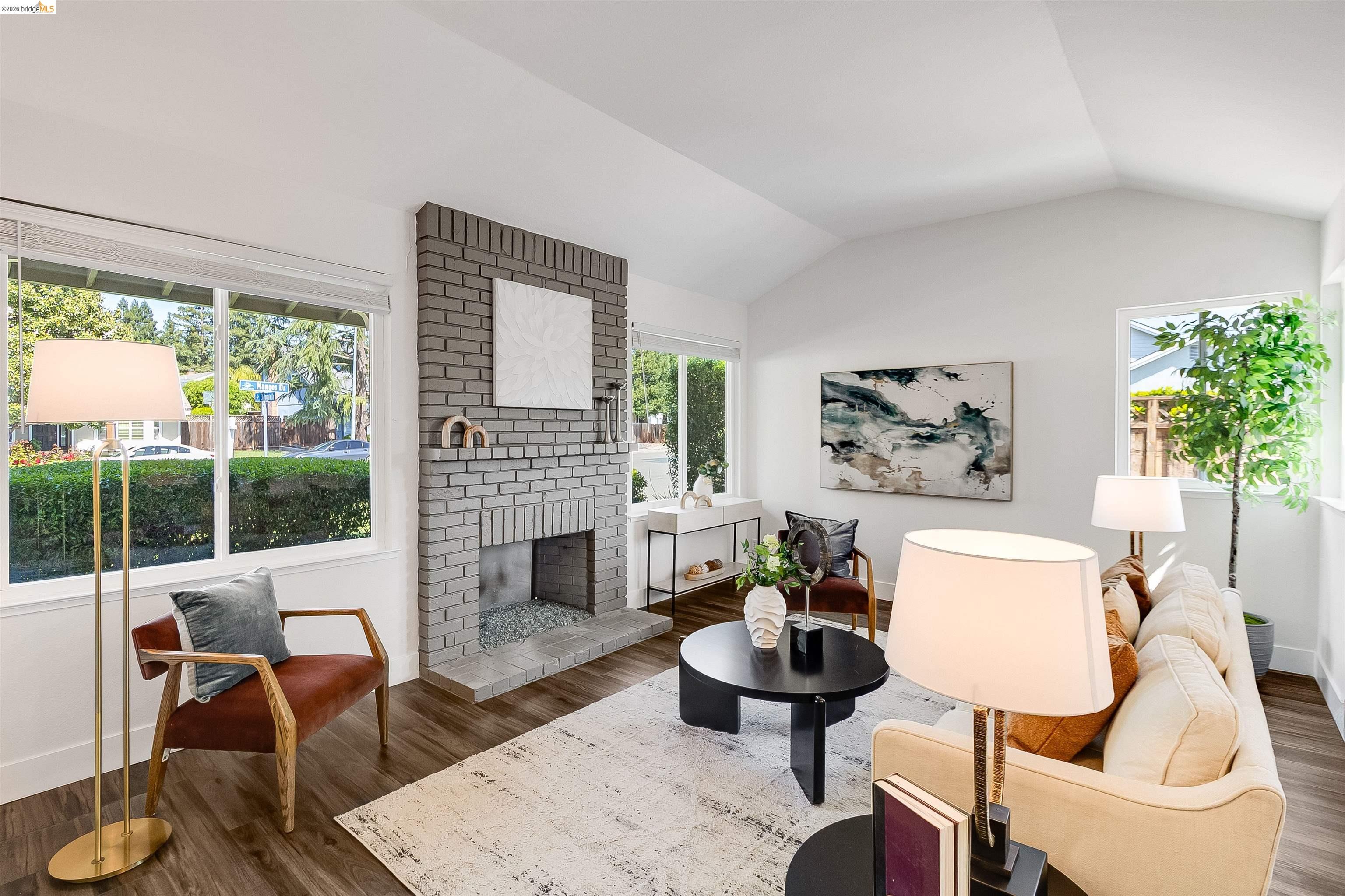 9980 Mangos Drive San Ramon, CA 94583 - Photo 7 of 41 Living area with a brick fireplace and wood finished floors