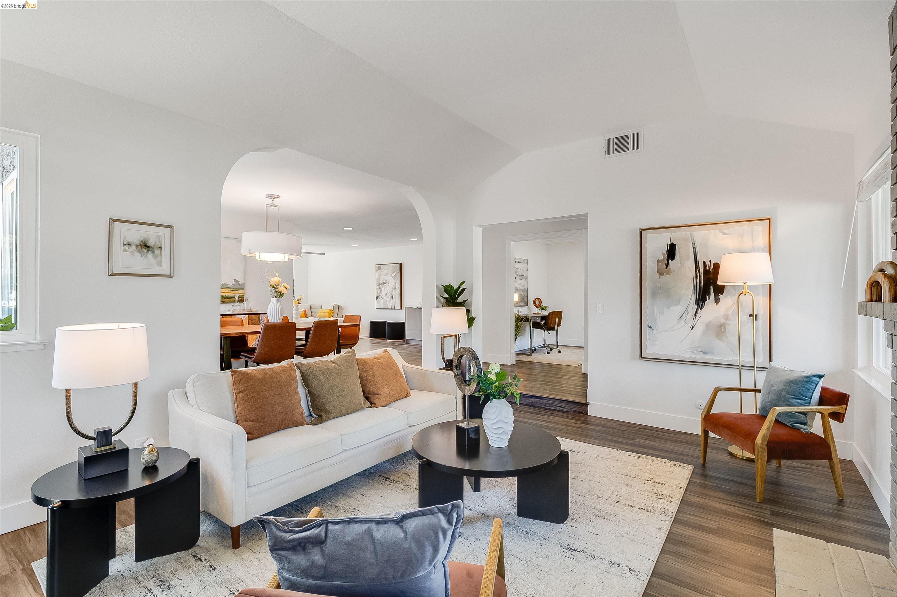 9980 Mangos Drive San Ramon, CA 94583 - Photo 8 of 41 Living room featuring wood finished floors, arched walkways, and lofted ceiling