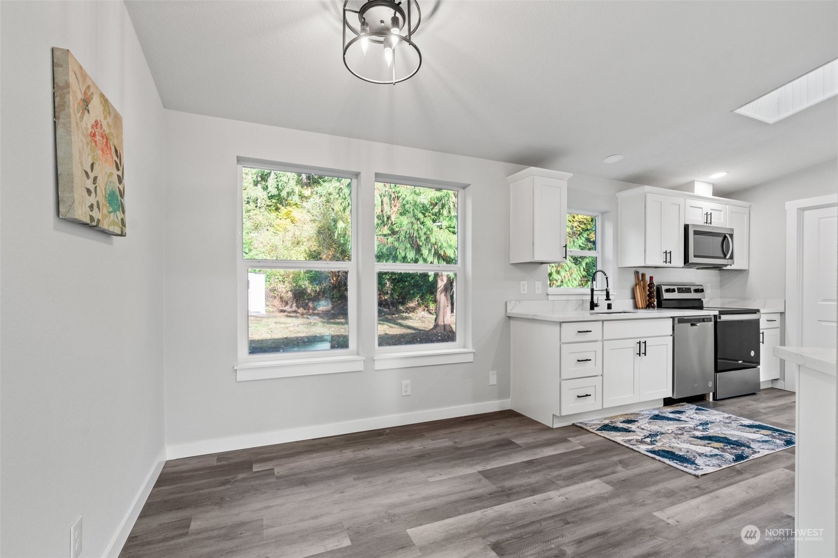 13314 Spring Site Road East Orting, WA 98360 - Photo 15 of 28 a kitchen with stainless steel appliances kitchen island granite countertop a stove a sink and a window