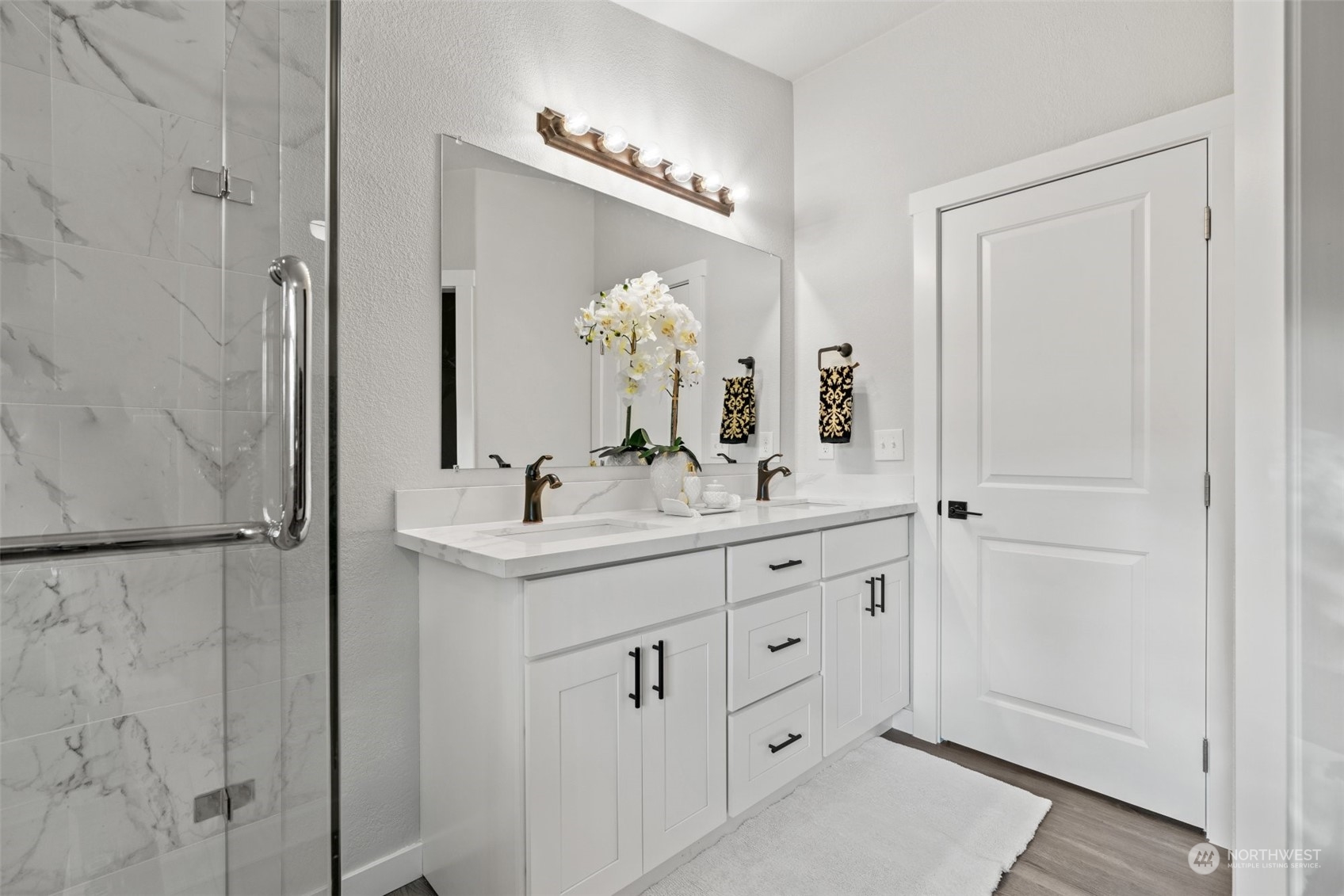 13314 Spring Site Road East Orting, WA 98360 - Photo 18 of 28 a bathroom with a double vanity sink and mirror