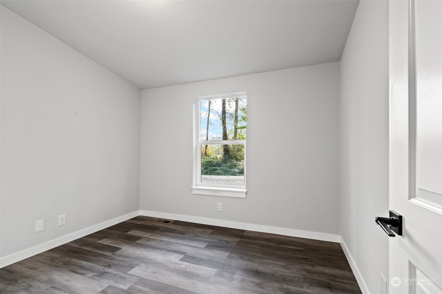 13314 Spring Site Road East Orting, WA 98360 - Photo 20 of 28 an empty room with wooden floor and windows