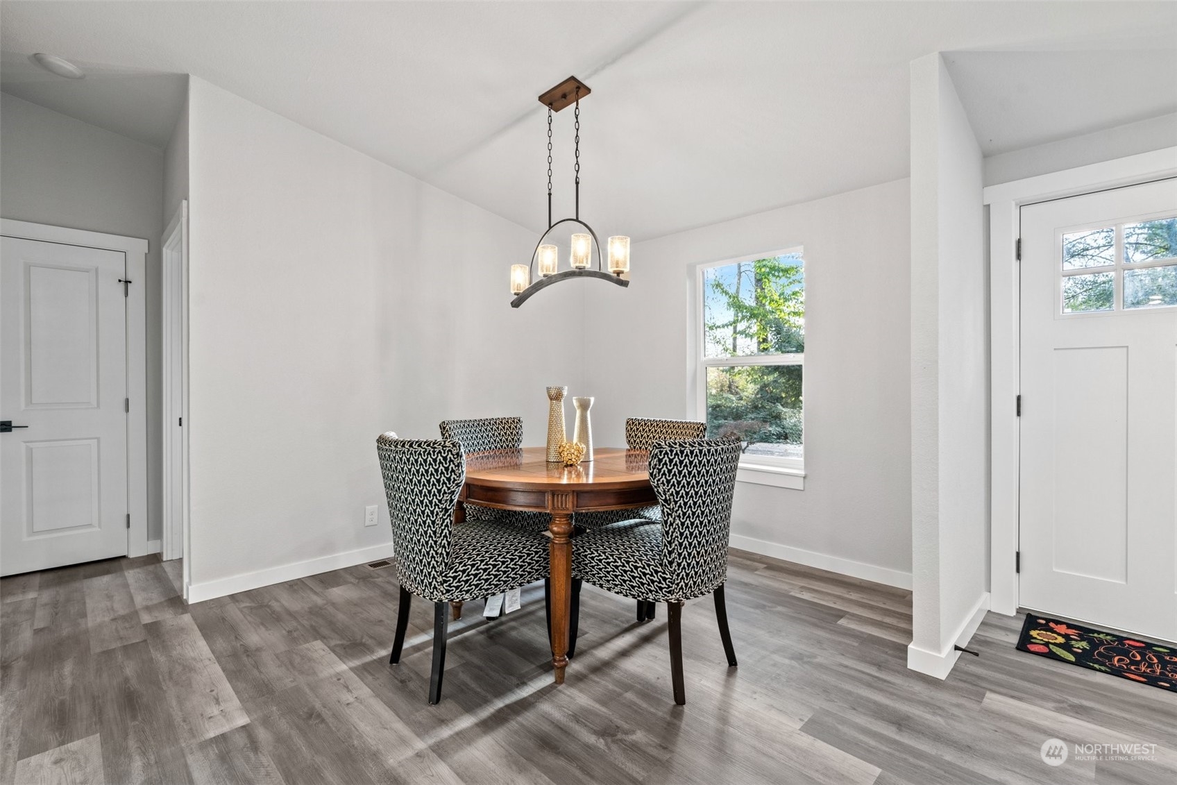 13314 Spring Site Road East Orting, WA 98360 - Photo 8 of 28 a dining room with furniture window and wooden floor