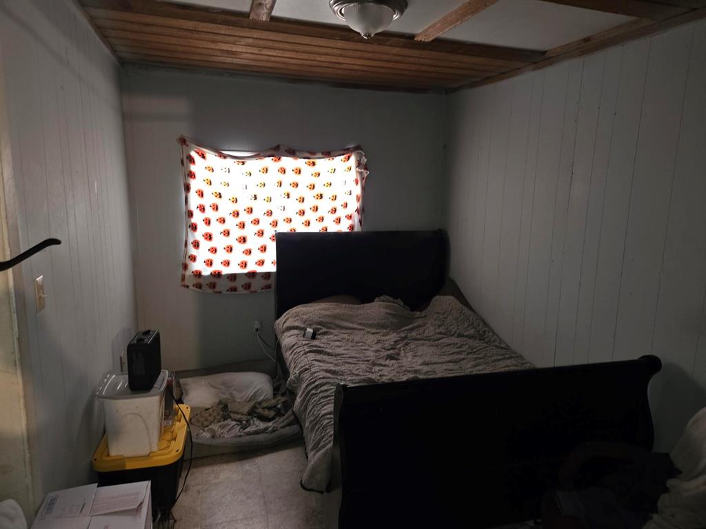 105 Royal Lane Princeton, TX 75407 - Photo 11 of 14 a bed sitting in a bedroom next to a window with potted plants