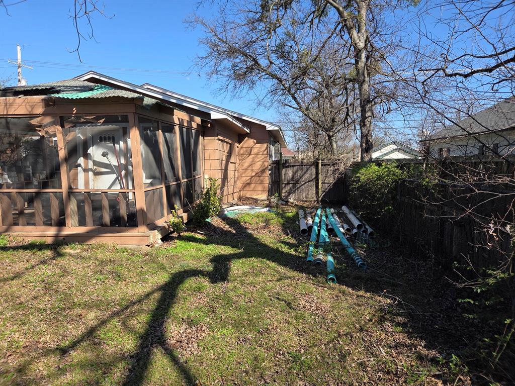 105 Royal Lane Princeton, TX 75407 - Photo 2 of 14 a view of a yard with table and chairs under an umbrella