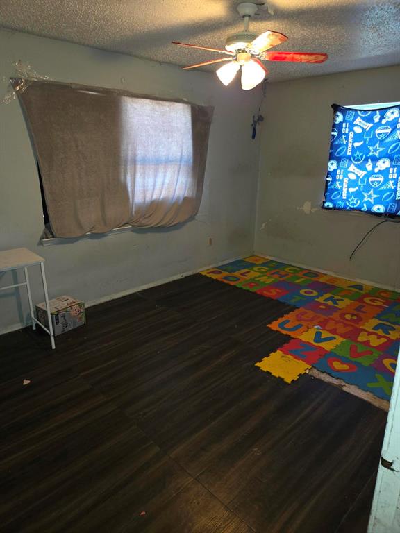 105 Royal Lane Princeton, TX 75407 - Photo 7 of 14 a room with wooden floor and windows