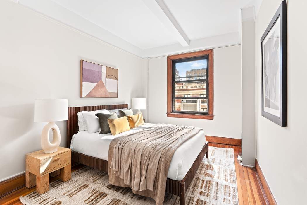 257 West 86th Street, Unit 78B Manhattan, NY 10024 - Photo 7 of 14 a bedroom with a bed and wooden floor