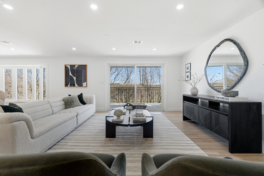 171 Shaw Road Brookline, MA 02467 - Photo 7 of 42 a living room with furniture and a large window