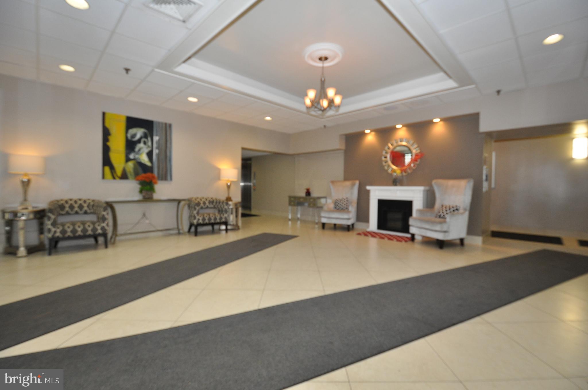 5911 Edsall Road, Unit 403 Alexandria, VA 22304 - Photo 3 of 29 a living room with fireplace furniture and a flat screen tv