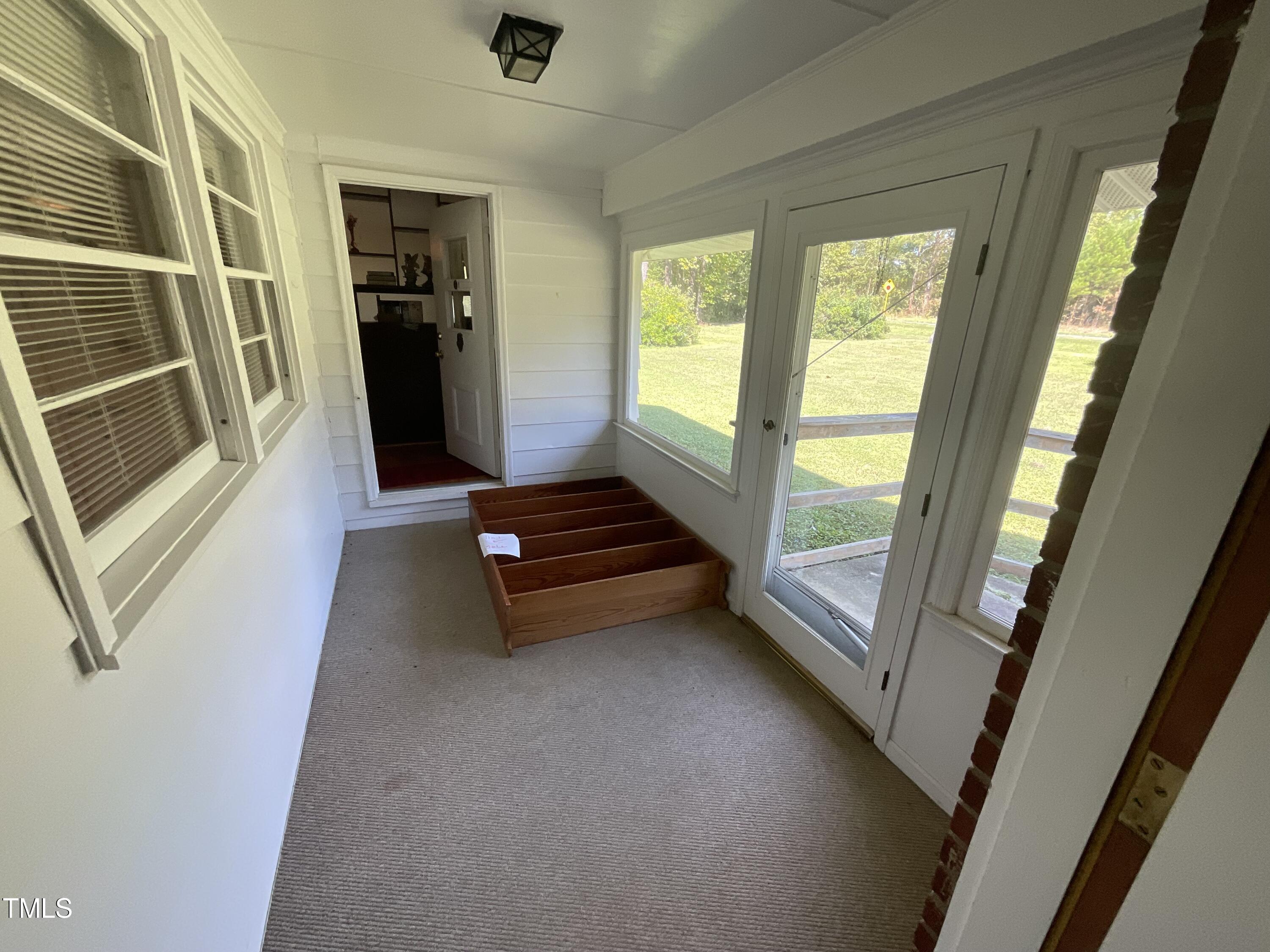 4540 Benson Road Angier, NC 27501 - Photo 12 of 27 a room with wooden floor and a window