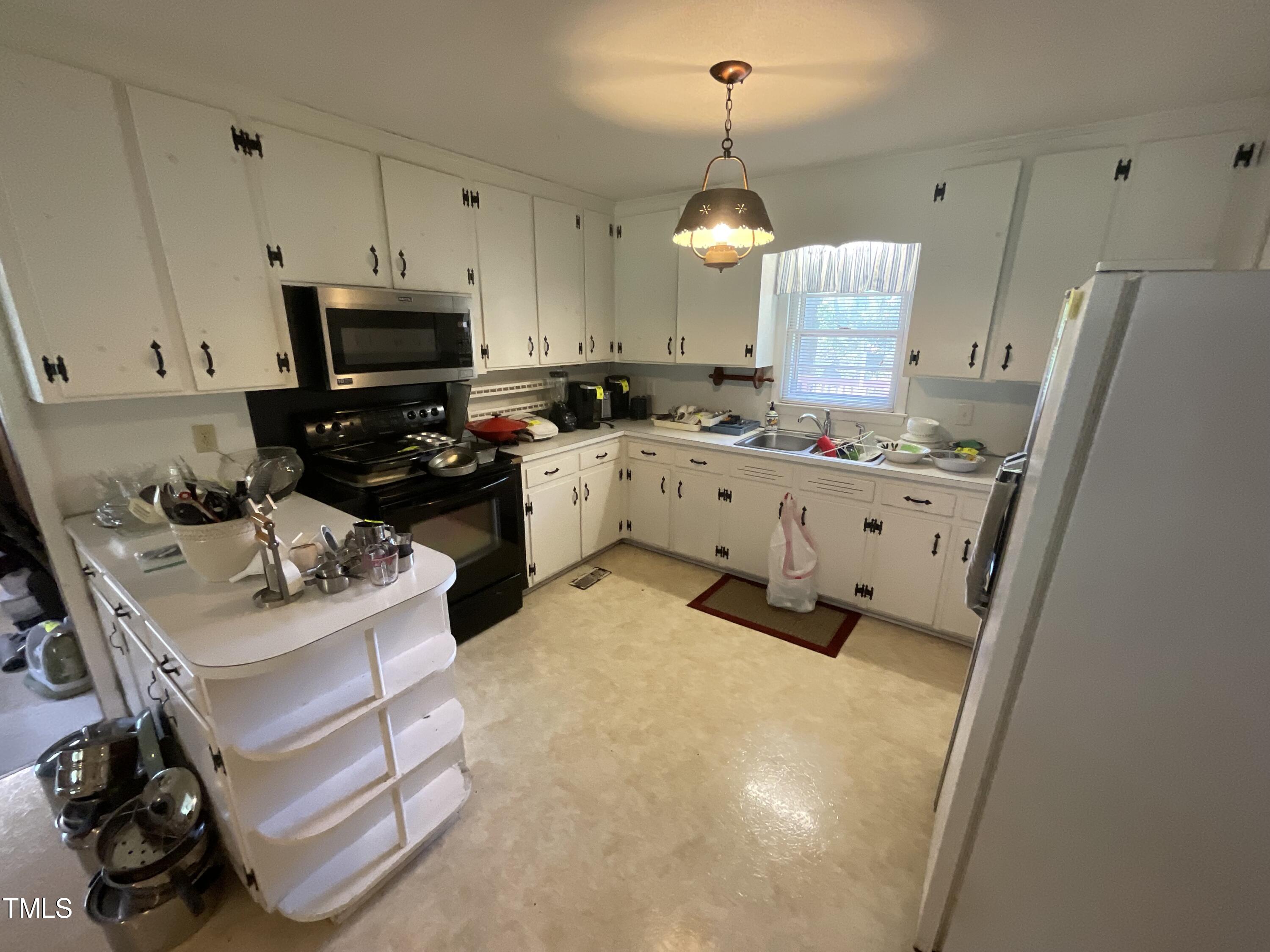 4540 Benson Road Angier, NC 27501 - Photo 14 of 27 a kitchen with stainless steel appliances a stove a sink and a refrigerator