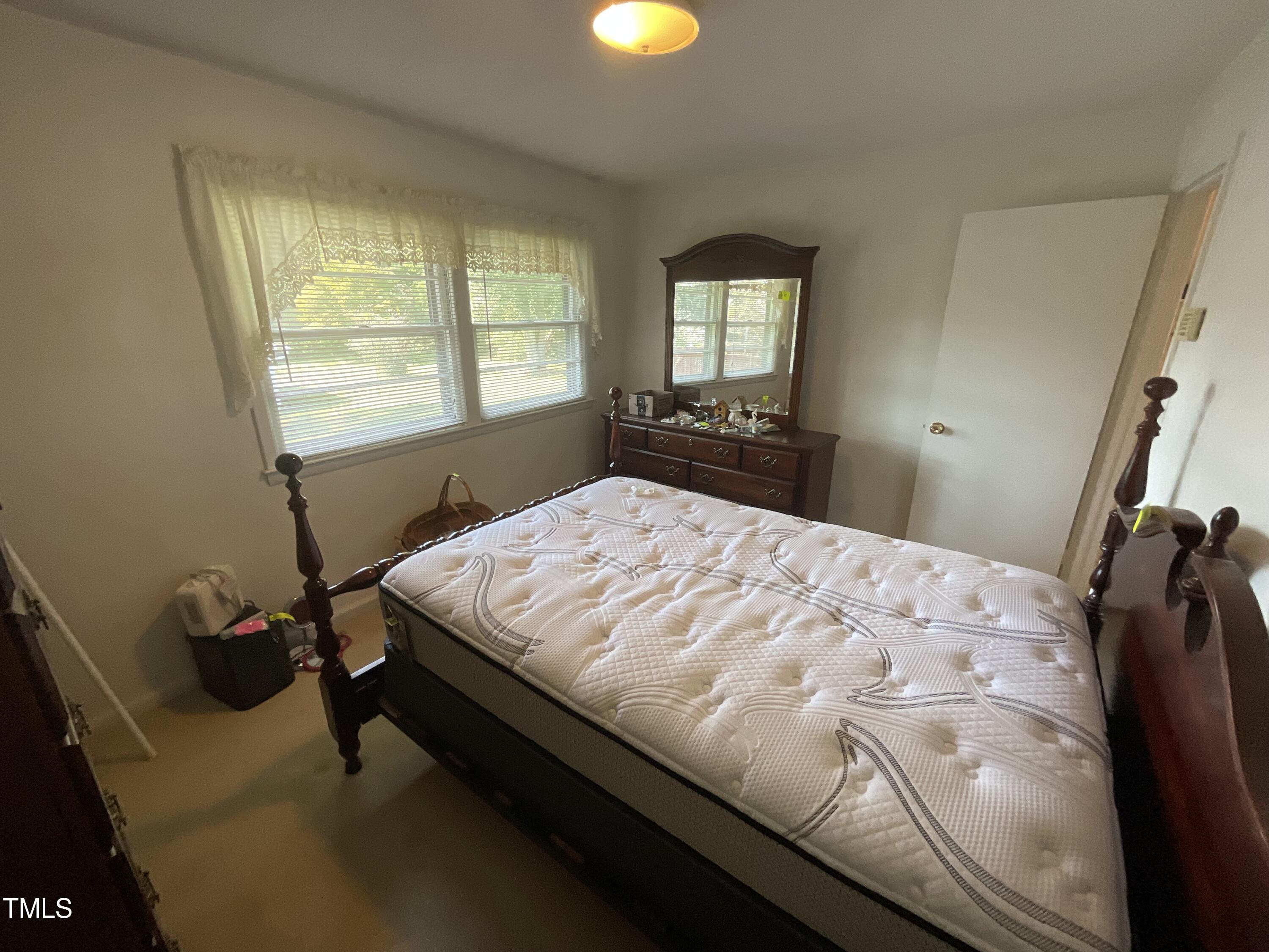 4540 Benson Road Angier, NC 27501 - Photo 20 of 27 a bed sitting in a bedroom next to a window