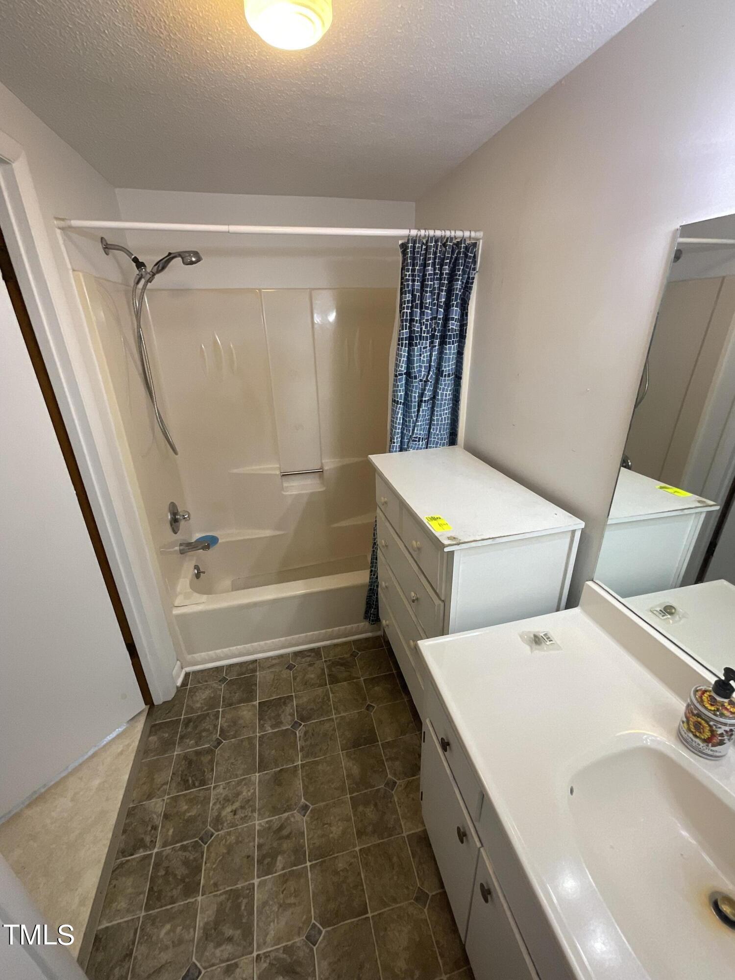4540 Benson Road Angier, NC 27501 - Photo 7 of 27 a bathroom with a tub shower and sink