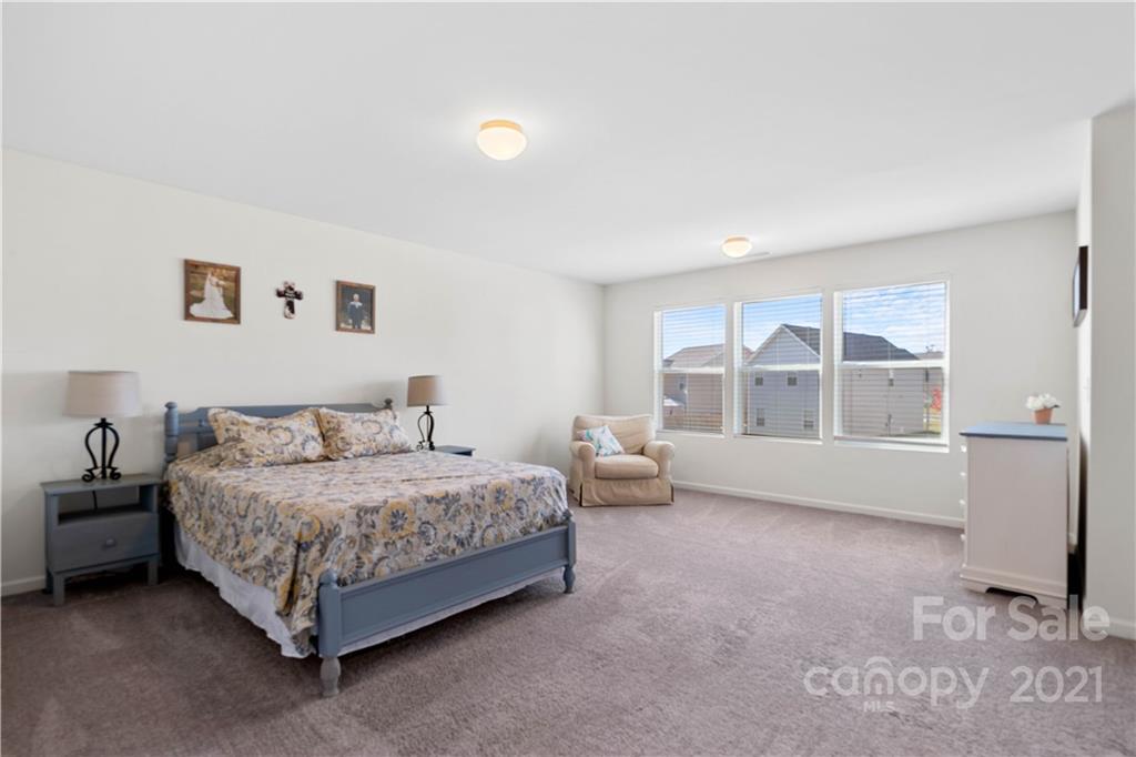 12510 Gotland Road Midland, NC 28107 - Photo 16 of 30 a spacious bedroom with a bed and a large window