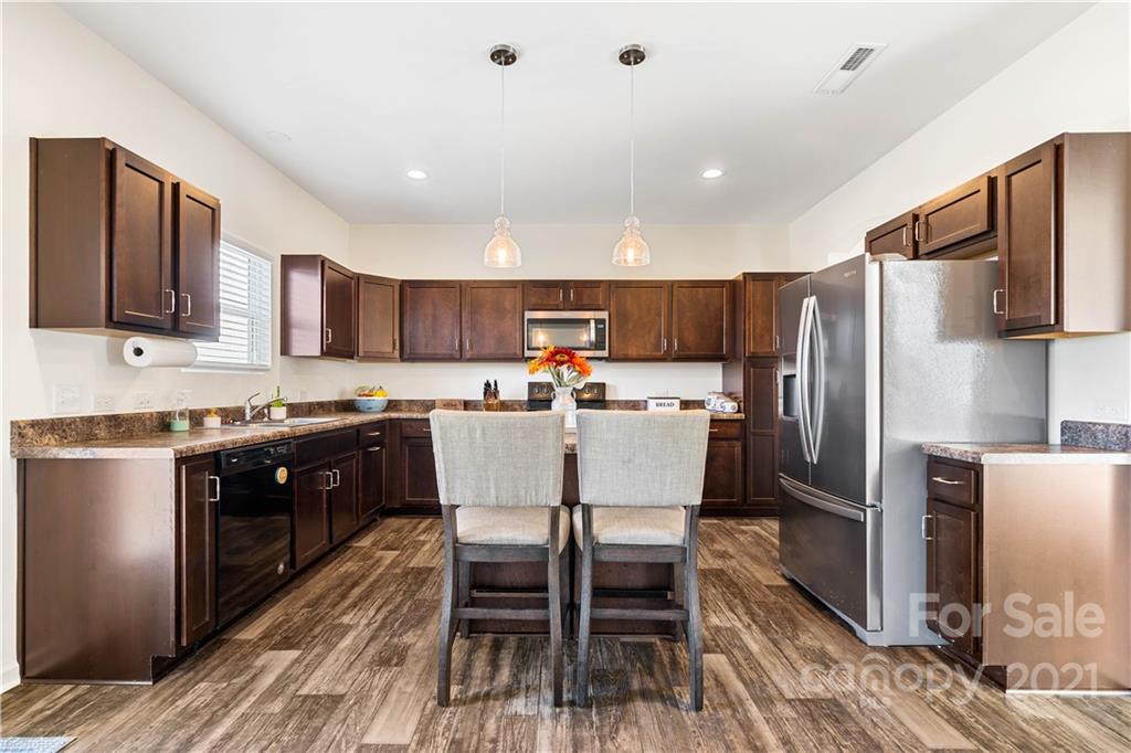 12510 Gotland Road Midland, NC 28107 - Photo 3 of 30 a kitchen with stainless steel appliances granite countertop a refrigerator a stove top oven a sink and dishwasher