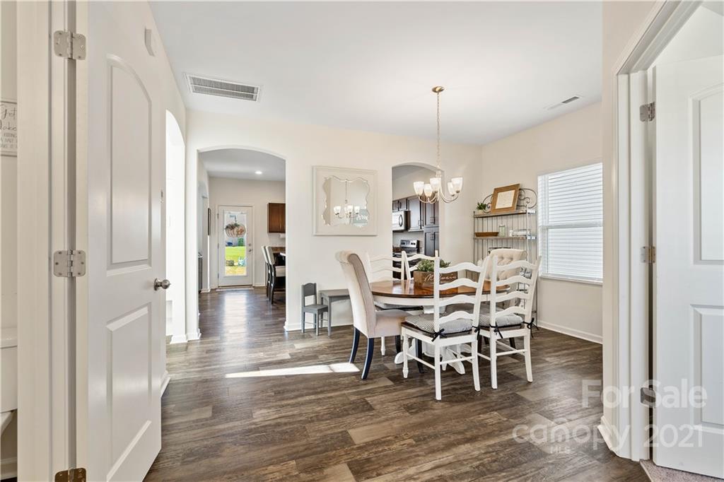 12510 Gotland Road Midland, NC 28107 - Photo 7 of 30 a view of a dining room with furniture and wooden floor