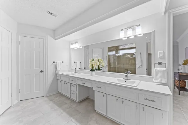 a spacious bedroom with a bed and a couch