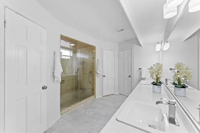a bathroom with a double vanity sink and a mirror