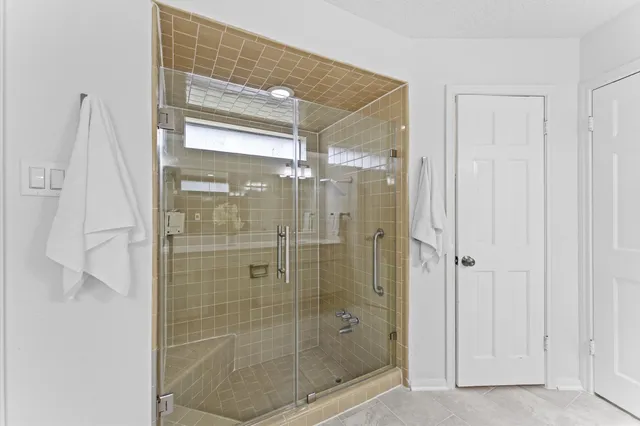a bathroom with a tub shower and a sink