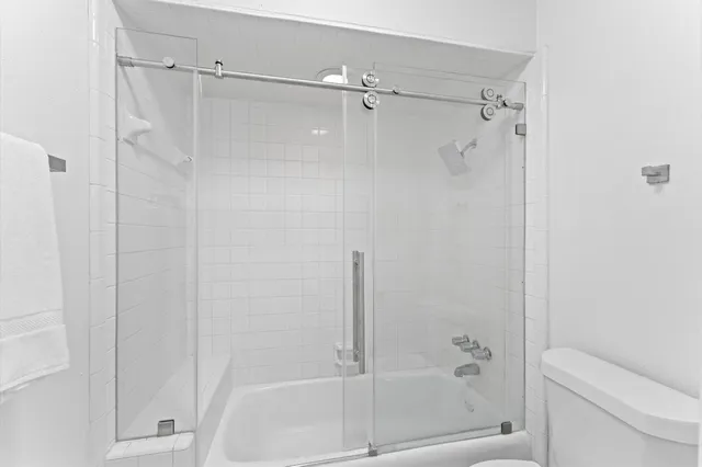 a bathroom with a shower and a toilet