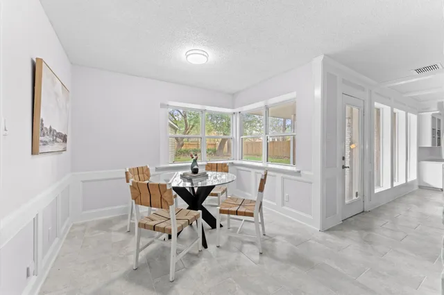 a dining room with furniture and window