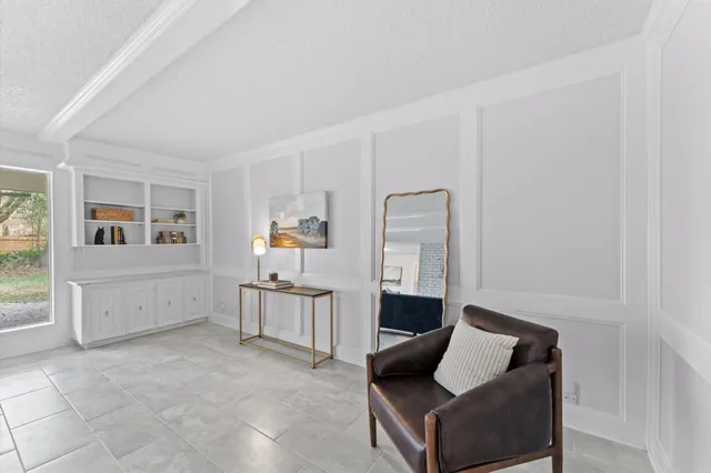 a living room with furniture a fireplace and a table