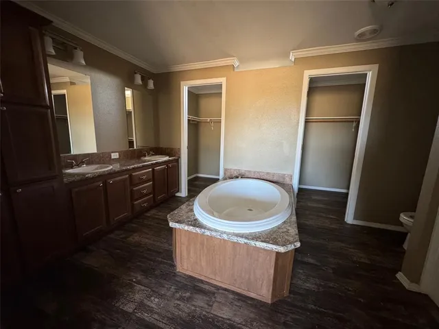 a large kitchen with a sink a refrigerator and a stove