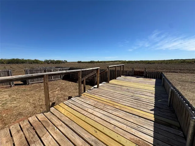 a view of a balcony with wooden floor and city view