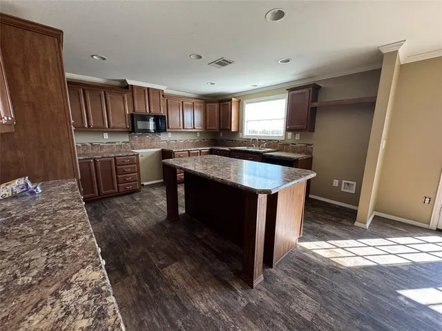 a kitchen with a sink stove and cabinets