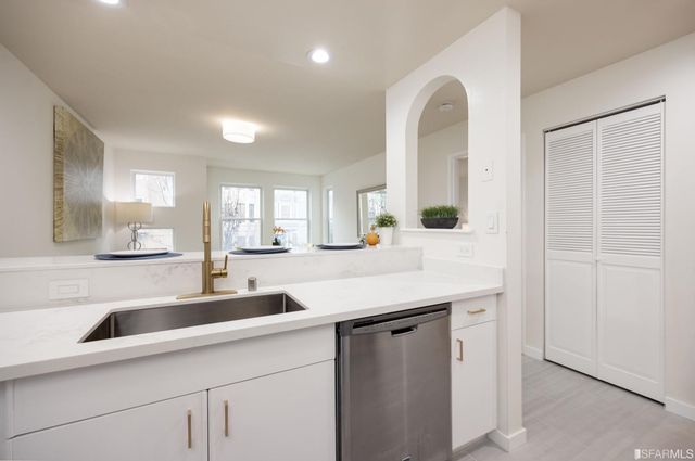 a kitchen with a sink and a refrigerator