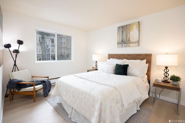 a bedroom with bed and chair