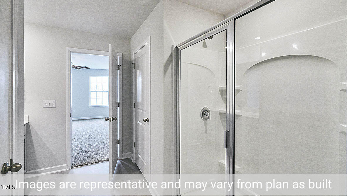 1702 Carter Daniel Drive Graham, NC 27253 - Photo 20 of 27 a bathroom with a shower and a glass door