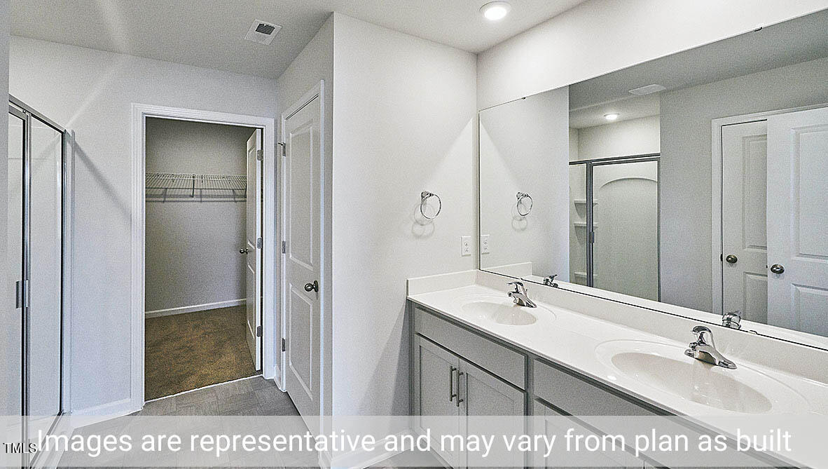 1702 Carter Daniel Drive Graham, NC 27253 - Photo 22 of 27 a bathroom with a sink a shower and a mirror