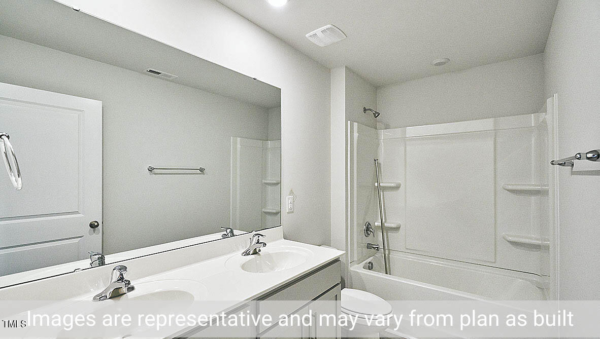 1702 Carter Daniel Drive Graham, NC 27253 - Photo 25 of 27 a bathroom with a tub a sink and mirror